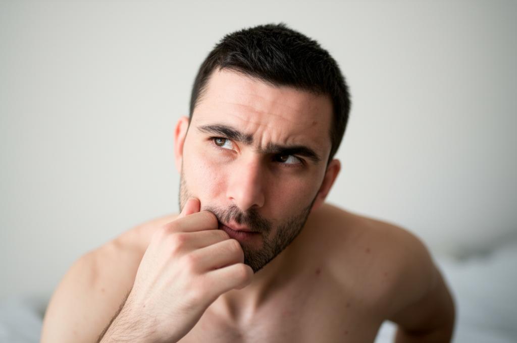 A man looking thoughtful or slightly concerned about his energy levels