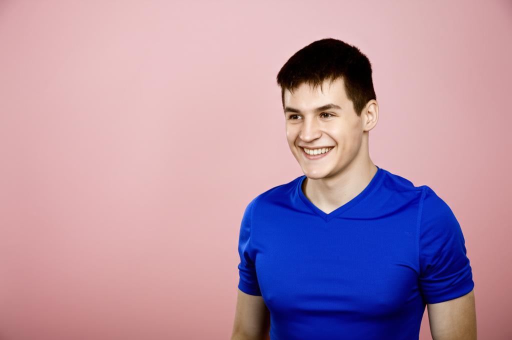 Young man looking energetic and smiling, perhaps working or exercising