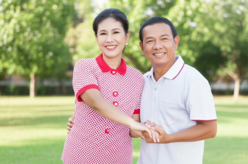 Happy middle-aged Thai couple smiling and holding hands, looking energetic