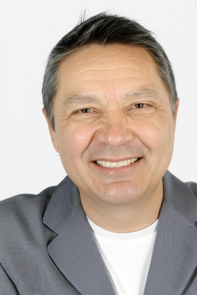 Middle-aged man looking healthy and confident smiling